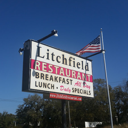 Litchfield Restaurant Sign with an American flag in the distance