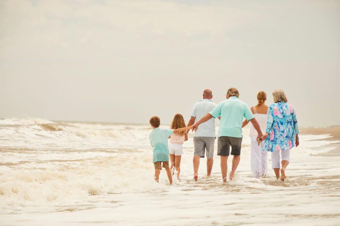 Family walking on the beach in Pawleys Island, SC