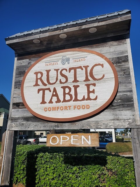 A tall wooden sign that says 